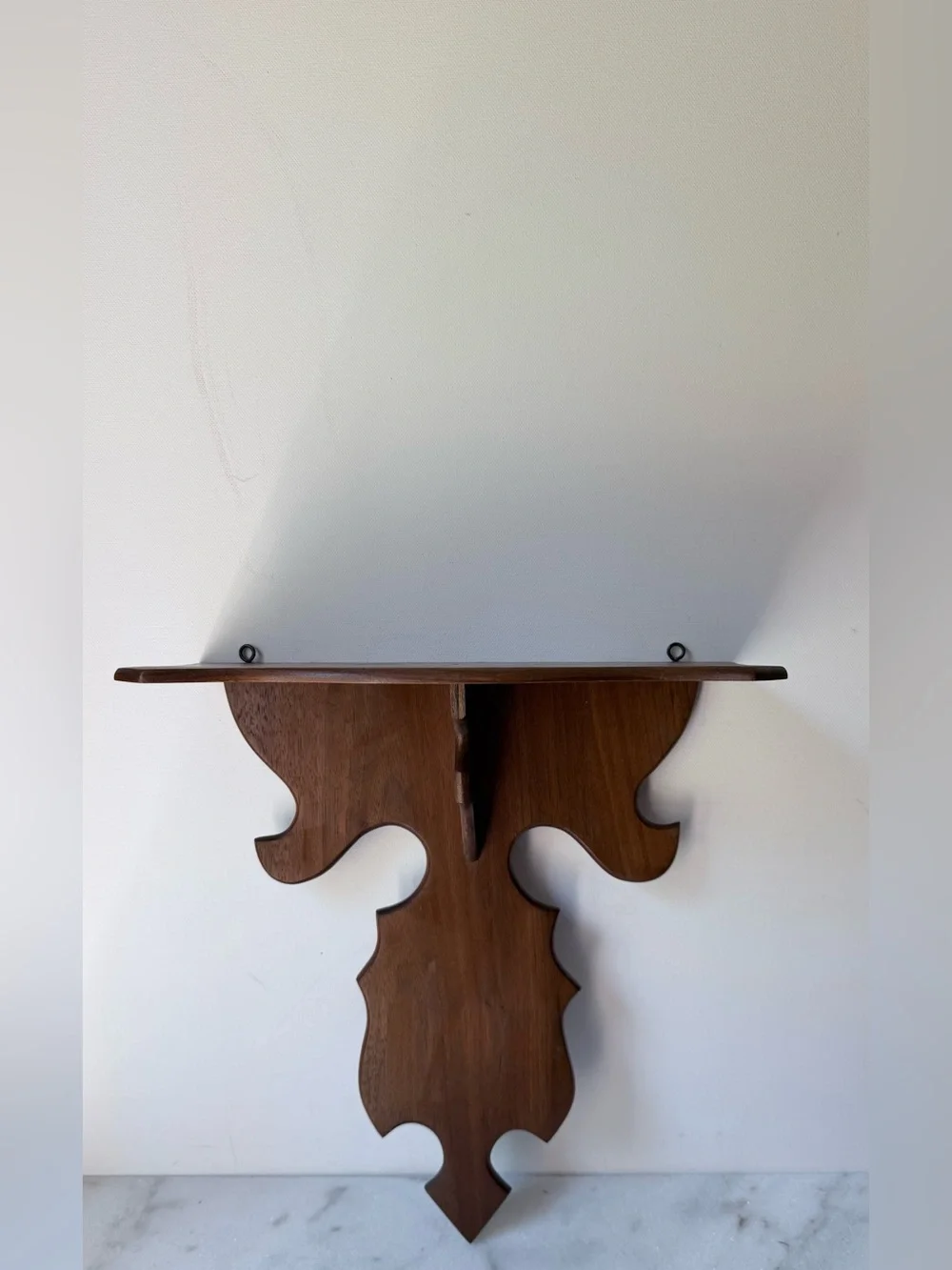 vintage wall sconce shelf made of carved wood with a dark finish